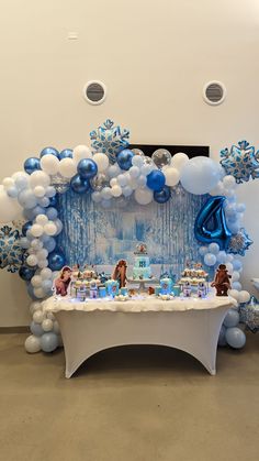 a table with balloons and decorations on it