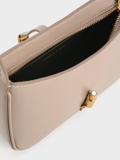 This product is made with at least 20% sustainable materials by weight. CHARLES & KEITH uses recycled, degradable, organic, and water-based materials in our eco-conscious collection. Taupe is the neutral colour to be seen in this season. An elegant blend of brown and grey, this understated hue will bring a refreshing touch to your new seasonal everyday wardrobe. Consider incorporating it in the form of the Cesia, featuring a clean-lined silhouette that will effortlessly elevate any look with elegance. It is distinguished by its metallic gold accent, which not only serves as a decorative element but also as a functional magnetic closure, ensuring the safety and security of your personal belongings. Personal Belongings, Charles Keith, Gold Accent, Sustainable Materials, Eco Conscious, Safety And Security, Metallic Accents, Everyday Wardrobe, Metallic Gold