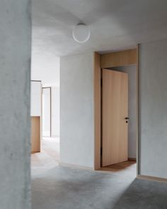 an empty room with wooden doors and white walls