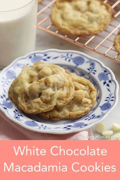 white chocolate macadamia cookies on a blue and white plate next to a glass of milk