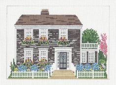 a cross stitch house with flowers on the front and side windows, along with a white picket