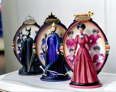 three figurines are sitting on top of a shelf in front of a mirror