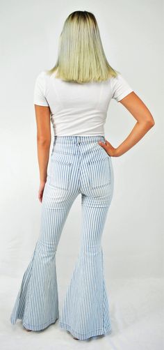 Feel-good retro stripes. An updated throwback, these jeans are cool! The high waist denim jeans fit snugly to the knee then flare to a bell bottom. The denim has light wash stripes with front and back square pockets to give that retro feel. A great pair of lightweight jeans to wear all year long. Color- Light Blue and White 65% Cotton 33% Polyester 2% Spandex Trendy Cotton Jeans With Vertical Stripes, Striped Straight Leg Denim Jeans, Striped Straight Leg Cotton Jeans, Trendy White Spring Flares, Casual Striped Flare Bottoms, Casual Flared Striped Bottoms, Trendy Bottoms With Striped Hem For Spring, Spring Striped Flare Bottoms, Trendy Blue Bottoms With Vertical Stripes