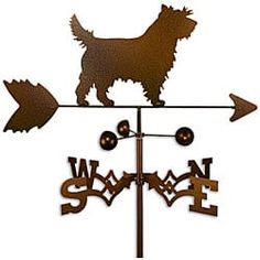 a weather vane with an image of a dog on it's top and two arrows pointing in opposite directions