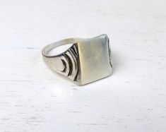 Vintage sterling silver signet ring. The front of the ring is square shaped. M a r k e d: SILVER M e a s u r e s: 🇺🇸 US size 8¾, Inner Diameter 19mm, front part rectangle 13x11mm, weight 3.86grams C o n d i t i o n: very good vintage preloved condition More Scandinavian sterling silver rings here: https://www.etsy.com/shop/AnteBellumTreasure?ref=seller-platform-mcnav&section_id=38939926 Thank you for your interest! Modernist Rectangular Signet Ring For Anniversary, Silver Rectangular Signet Ring For Formal Occasions, Vintage Silver Rectangular Ring, Rectangular Silver Signet Anniversary Ring, Silver Rectangular Signet Ring For Anniversary, Classic Rectangular Signet Ring Stamped 925, Rectangular Silver Engraved Ring Stamped 925, Vintage Rectangular Signet Ring With Polished Finish, Rectangular Modernist Signet Ring With Polished Finish