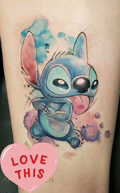 the tattoo on the leg of a woman is painted with watercolors and features an image of stitch