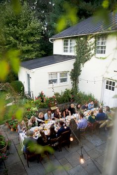 a group of people sitting around a table outside