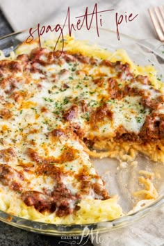 a pizza pie with one slice missing from it on a glass plate next to a fork and knife