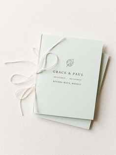 two wedding cards tied together with twine on top of each other and the words grace & paul printed on them