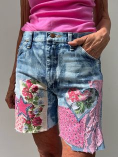 a woman in pink shirt and blue jean shorts with flowers on it's side