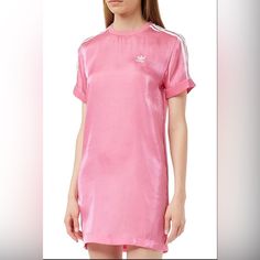 Elevate Your Style With This Adidas Women's Dress In A Beautiful Rose Tone Satin Fabric. The Dress Features Three Stripes Above The Knee And An A-Line Style That Flatters Any Figure. The Short Sleeve And Crew Neck Design Make It Perfect For Both Travel And Casual Occasions. The Dress Is Made Of High-Quality Polyester Material And Has Embroidered Logo Accents That Add A Touch Of Elegance. This Dress Is A Must-Have For Any Fashion-Forward Woman. The Classic Theme And Striped Pattern Make It A Vers Spring Satin Mini Dress With Short Sleeves, Pink Satin Dress With Short Sleeves, Pink Satin Short Sleeve Dress, Adidas Mini Dress For Spring, Fitted Adidas Mini Dress, Adidas Fitted Mini Dress, White Adidas Dress For Spring, Adidas White Dress For Spring, Adidas Short Sleeve Spring Dresses