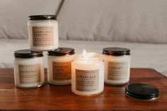 five candles sitting on top of a wooden table