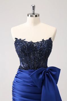 a dress on a mannequin with a blue bow