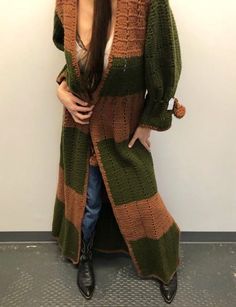 "Vintage hand knit olive green and chestnut brown duster cardigan with side slits and braided waist and sleeve ties (with pompoms). 16.5\" armpit to armpit / 40\" waist (unsinched) / 20\" sleeves / 61\" length" Bohemian Brown Sweater Coat For Fall, Long Green Sweater Coat For Fall, Bohemian Green Cardigan For Fall, Green Bohemian Cardigan For Fall, Long Green Sweater For Fall, Hand Knitted Long Sweater For Fall, Hand Knitted Brown Outerwear For Fall, Hand Knitted Long Outerwear For Fall, Long Green Fall Sweater