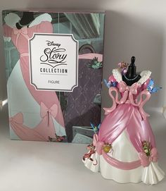 the figurine is next to the box for the disney story collection dollhouse