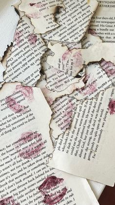 several pieces of torn paper with red ink on them