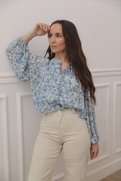 The blue floral blouse is a stylish and elegant long sleeve button down top. The beautiful floral print in shades of blue adds a touch of femininity to the blouse, making it perfect for any occasion. The comfortable and breathable material of the blouse ensures that you can wear it all day long without feeling uncomfortable. Pair it with your favorite pair of jeans or skirt for a chic and sophisticated look. blue floral print pattern balloon sleeves button placket elasticized band at waist shirr Light Blue Long Sleeve Blouse For Spring, Chic Flowy Blouse With Floral Print, Fall Floral Print Light Blue Top, Fall Light Blue Floral Print Top, Chic Floral Print Button-up Blouse, Feminine Floral Print Button-up Blouse, Chic Light Blue Floral Print Top, Blue Floral Print Blouse For Fall, Chic Floral Print Long Sleeve Blouse