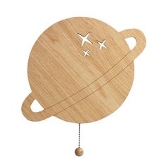 a wooden toy with an airplane on it's back and two smaller airplanes flying in the sky