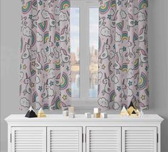 the curtains in this room are decorated with unicorns and rainbows