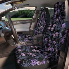 the interior of a car with purple flowers and black leather seat covers in front of it