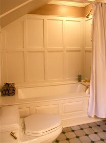 a white toilet sitting next to a bath tub in a bathroom