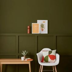 a chair and table in a room with green walls