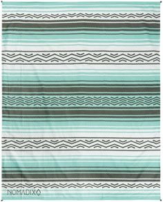 a green and white blanket with stripes on it