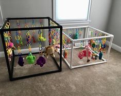 two playpens with stuffed animals and toys in them on the floor next to each other