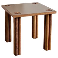 a small wooden table with four legs and holes in the top, on a white background