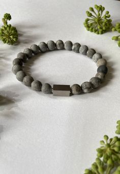 Matte Maifan Stone and brush silver spacer Mens Bracelet, Unisex Bracelet, Healing Stone, Rejuvenation Bracelet, Healing Minerals, Holistic Bracelet, Fashion Bracelet, Yoga Bracelet, Urban Jewelry, Grey stone Bracelet  This unique elastic bracelet is made with 8mm or 6mm natural Matte Maifan stone beads and brush silver spacer  Bracelets measures approximately 19 cm but can be made to a different size upon request Comes gift wrapped ready to give or to keep Maifan stone has meaning and properties to enhance health. It is known in Chinese medicine as a remedy for skin diseases. It is not surprising since it contains rich set of minerals: calcium, iron, zinc, magnesium, copper and selenium, which are necessary for the health of the human body. Since the ancient times maifan has been used as Modern Silver Bracelets With Gemstone Beads, Gray Spiritual Bracelets As Gift, Gray Spiritual Bracelet For Gift, Spiritual Gray Bracelets As Gifts, Silver Minimalist Beaded Bracelets With Natural Stones, Adjustable Gray Spiritual Bracelet, Adjustable Spiritual Gray Bracelet, Minimalist Silver Bracelet With Gemstone Beads, Gray Adjustable Spiritual Bracelet