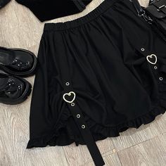 Buckle up with this Heart Buckle Skirt! Size Chart: Size Waist (cm) Length (cm) Waist (in) Length (in) One Size 62-86 45 24.41-33.86 17.72 Description: Silhouette: AsymmetricalMaterial: Cotton/SpandexDecoration: ButtonOrigin: CN(Origin)Waistline: EmpirePattern Type: SolidDresses Length: Above Knee, MiniFabric Type: BroadclothSkirt length: Short Skirt Cute Black Bottoms For Party, Cute Black Mini Skirt For Party, Cute Fitted Black Skirt, Cute Black Mini Skirt For Spring, Cute Black Party Skirt, Cute Black Summer Skirt, Cute Black Summer Skort, Cute Black Skort For Summer, Gothic Skort For Spring