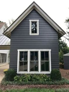 a gray house with white trim and windows