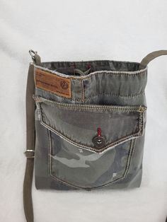 This small crossbody bag is handmade from upcycled jeans with a camouflage pattern. Soft and comfortable to wear. A handy bag for everyday use. There are 1 zipper pocket inside the bag. Adjustable shoulder strap. The bag is practical for various occasions.  It has 2 pockets at the front  for extra small items. Each piece is unique and only available once. Every Bag will be different and unique. One of a kind. PLEASE double check the measurements. MEASUREMENTS: Height:  26 cm Width:  23 cm Strap Casual Upcycled Shoulder Bag, Casual Upcycled Crossbody Shoulder Bag, Casual Camouflage Shoulder Bag For Everyday Use, Casual Camouflage Bags For Everyday Use, Sewing Slippers, Jeans Ideas, Upcycled Jeans, Blue Jeans Crafts, Pattern Bag