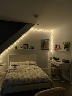 a bedroom with lights on the wall and a bed in it's corner,