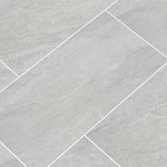 a tile floor with white lines in the middle and grey tiles on the bottom side