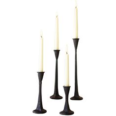 three black candlesticks sitting next to each other