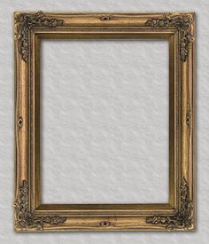 an old gold frame on a white wall