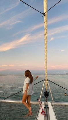 a woman standing on the deck of a boat