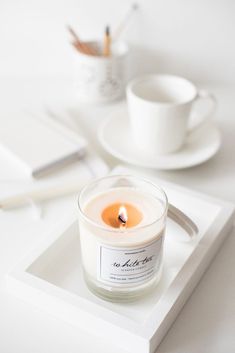 a candle sitting on top of a white tray