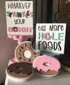 three donuts and two signs on a table