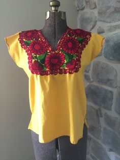 "This cute summer top is homemade and embroidered.  It is in great condition and would be a nice addition to your wardrobe, for almost any occasion.  Size could vary depending on how you like your clothes to fit.  It is a box style - so if you like your clothes to fit looser, and your'e a size small, this would work. Could also be worn as a cute cropped shirt with a waste banded added or bottom removed.  Size - Small Armpit to Armpit - 21\" Length Shoulder to Bottom - 23\"" Cute Embroidered Tops For Vacation, Cute Floral Embroidery Summer Tops, Cute Embroidered Summer Tops, Cute Embroidered Beach Tops, Yellow Floral Embroidery Tops For Vacation, Cute Multicolor Embroidered Tops For Spring, Cute Multicolor Embroidery Tops For Spring, Casual Cotton Tops With Embroidered Neckline, Yellow Floral Embroidery Blouse For Vacation