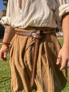 A belt perfect for any warrior. With an ornamental "Sleipnir" buckle and a bicolored tooled belt left long for the tied-off look. Made out of 7-8 oz veg tanned leather, meticulously hand carved and dyed. ONE SIZE FITS MOST (28"-51") Tooled Belt, Viking Belt, Medieval Belt, Viking Style, Tool Belt, Veg Tan Leather, Christmas Deals, Adult Costumes, Vikings