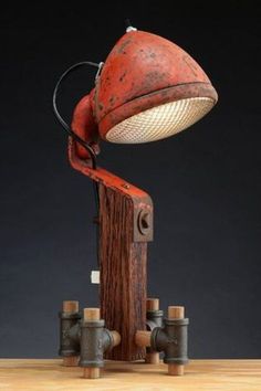 an old fashioned lamp is sitting on top of a wooden table