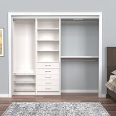 a bedroom with a bed, dresser and white closets on the wall next to it