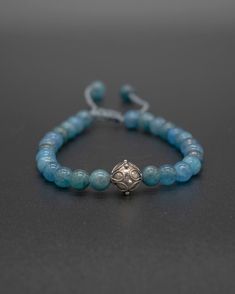 Crafted with an array of apatite beads and a beautiful silver crown accent, this handmade bracelet is the perfect way to add a natural touch of elegance. This bracelet is adjustable: Small fits 17cm [6in]-19cm [7.5in] wrist Adjustable Blue Apatite Bracelets, Adjustable Apatite Beaded Bracelets, Silver Crown, Mala Bracelet, Mala Necklace, Handmade Bracelet, Healing Stones, Ring Necklace, Handmade Bracelets