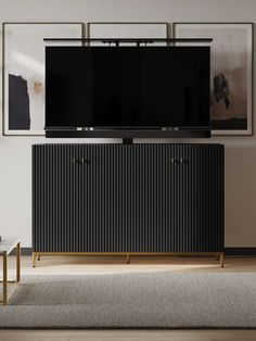 an entertainment center with a large television on top of it