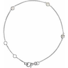 a silver chain bracelet with circles and charms on the clasp, set against a white background