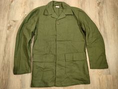 Swedish military jacket. These jackets have two front pockets with flap and button. Closed with buttons. The color may vary slightly depending on the jacket. Dimensions: size: C40 shoulders: 46 cm chest: 53cm length: 75 cm arm length: 59 cm The jacket is new size: C48 shoulders: 48 cm chest: 59cm length: 75 cm arm length: 60 cm The jacket is sewn back and front size: C50 shoulders: 47 cm chest: 61cm length: 76 cm arm length: 61 cm The jacket is sewn back on the right sleeve & there is a stain on Khaki Utility Jacket With Snap Buttons And Lapel Collar, Military Style Cotton Utility Jacket With Lapel Collar, Military Style Outerwear With Lapel Collar And Button Closure, Khaki Single-breasted Utility Jacket With Lapel Collar, Military Outerwear With Buttons And Lapel Collar, Military Outerwear With Lapel Collar And Buttons, Military Style Button-up Outerwear With Patch Pockets, Military Style Outerwear With Buttoned Pockets For Work, Military Style Single-breasted Button-up Outerwear