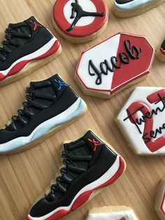 decorated cookies are arranged in the shape of basketball shoes and jordan's name on them