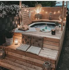 an outdoor hot tub with lights on the side and wooden steps leading up to it